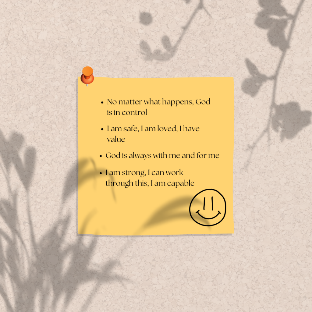 Yellow sticky note with encouraging text and smiley face pinned to cork board with orange thumb tack and flower shadows.